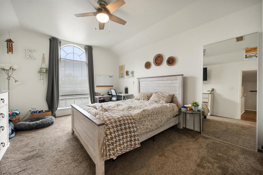 308 Faith Court Burleson, TX 76028 - Photo 27 of 40 a bedroom with a bed and a chandelier