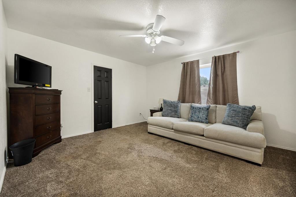 308 Faith Court Burleson, TX 76028 - Photo 28 of 40 a living room with furniture and a flat screen tv