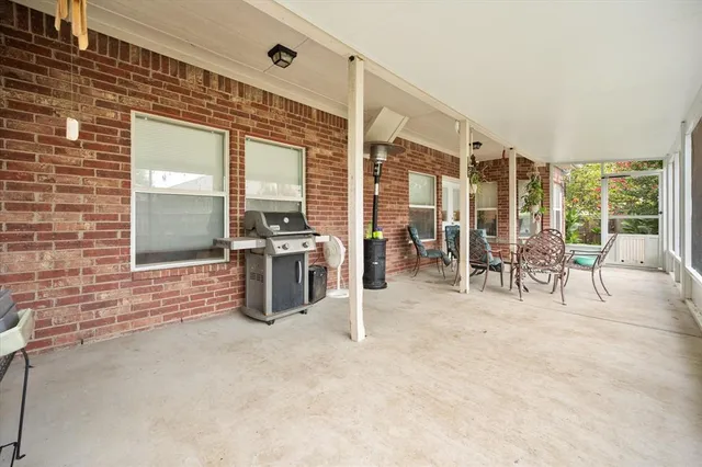 a front view of a house with a yard and potted plants