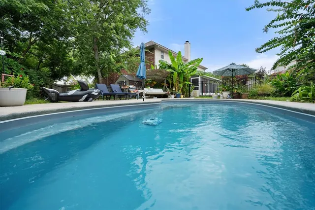 a view of a swimming pool with a patio