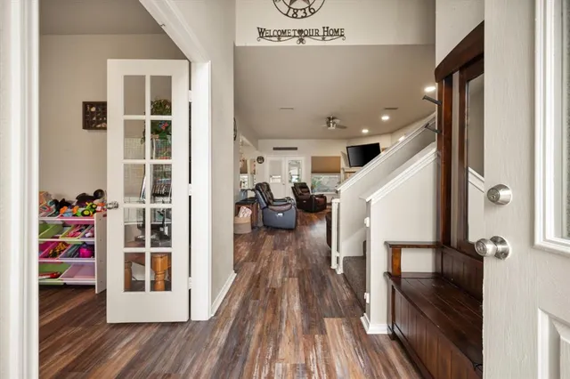 a view of a hallway view with wooden floor and staircase