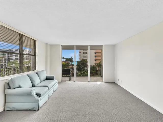 a living room with furniture and large windows