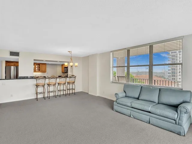 an empty room with windows and ceiling fan