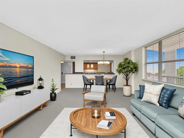 an empty room with windows and chandelier fan