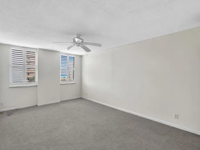 a bathroom with a granite countertop sink and white cabinets