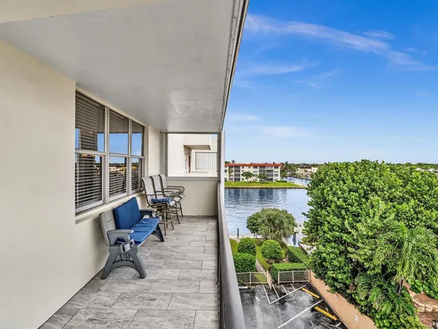 a kitchen with granite countertop white cabinets stainless steel appliances and a window
