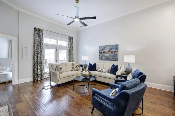 a living room with furniture a wooden floor and a window
