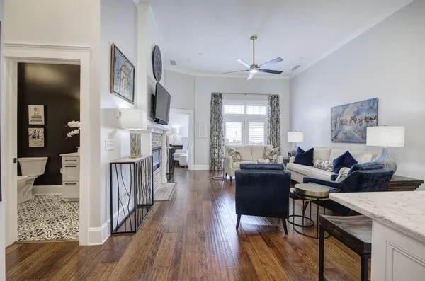 a living room with furniture and a wooden floor