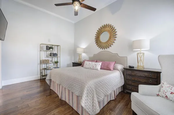 a bedroom with bed and a chandelier