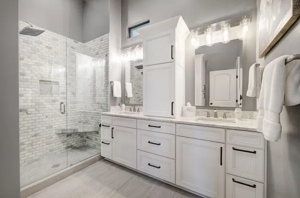 a bathroom with a granite countertop sink mirror and double