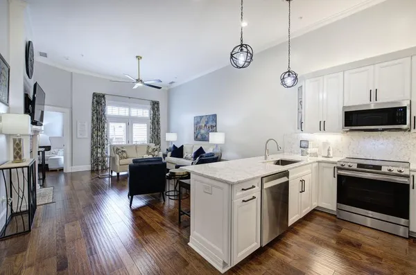a kitchen with a stove window and wooden floor