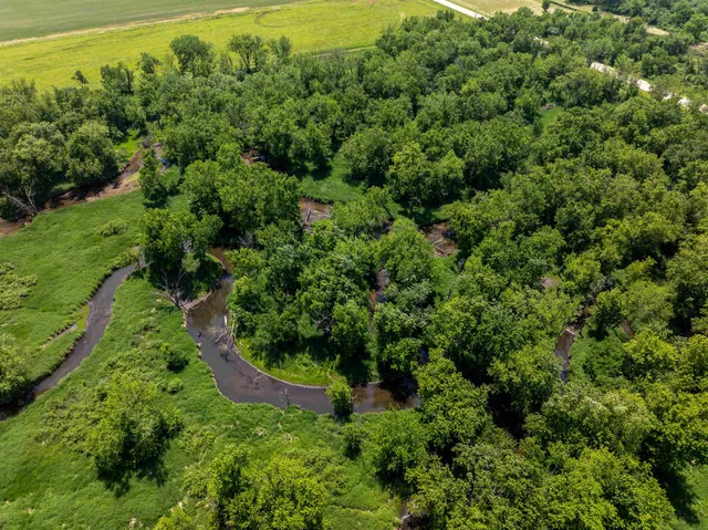 an aerial view of a houses with yard
