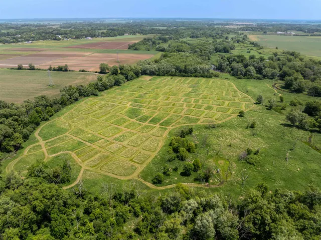 a view of a green field with an ocean view
