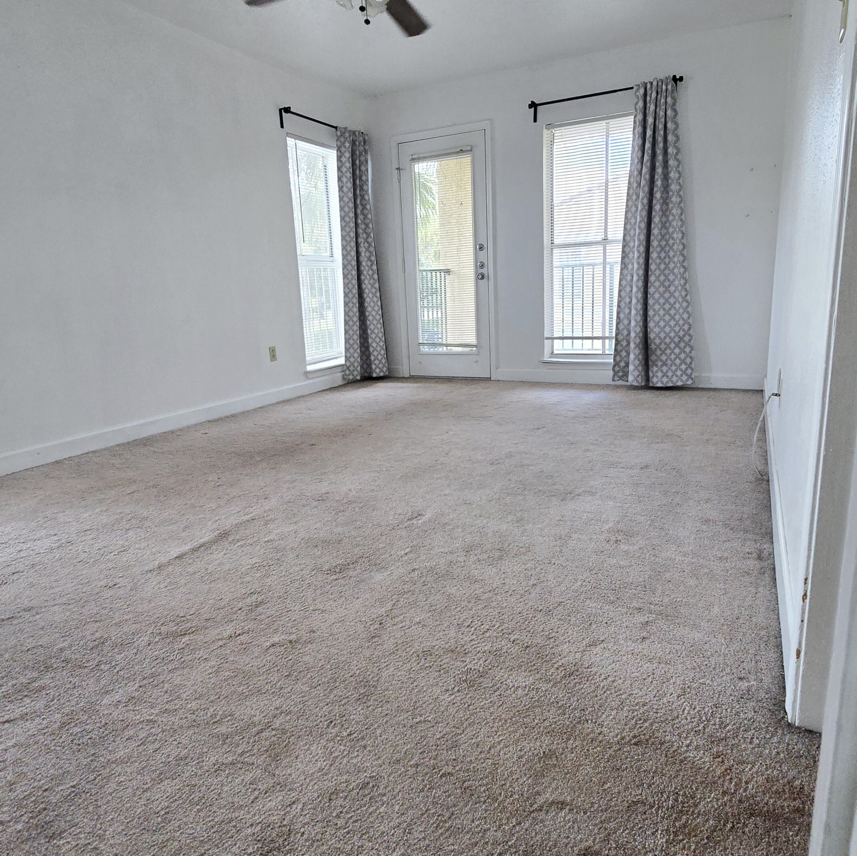 977 Riverside Drive, Unit 220 Coral Springs, FL 33071 - Photo 12 of 23 an empty room with windows and closet