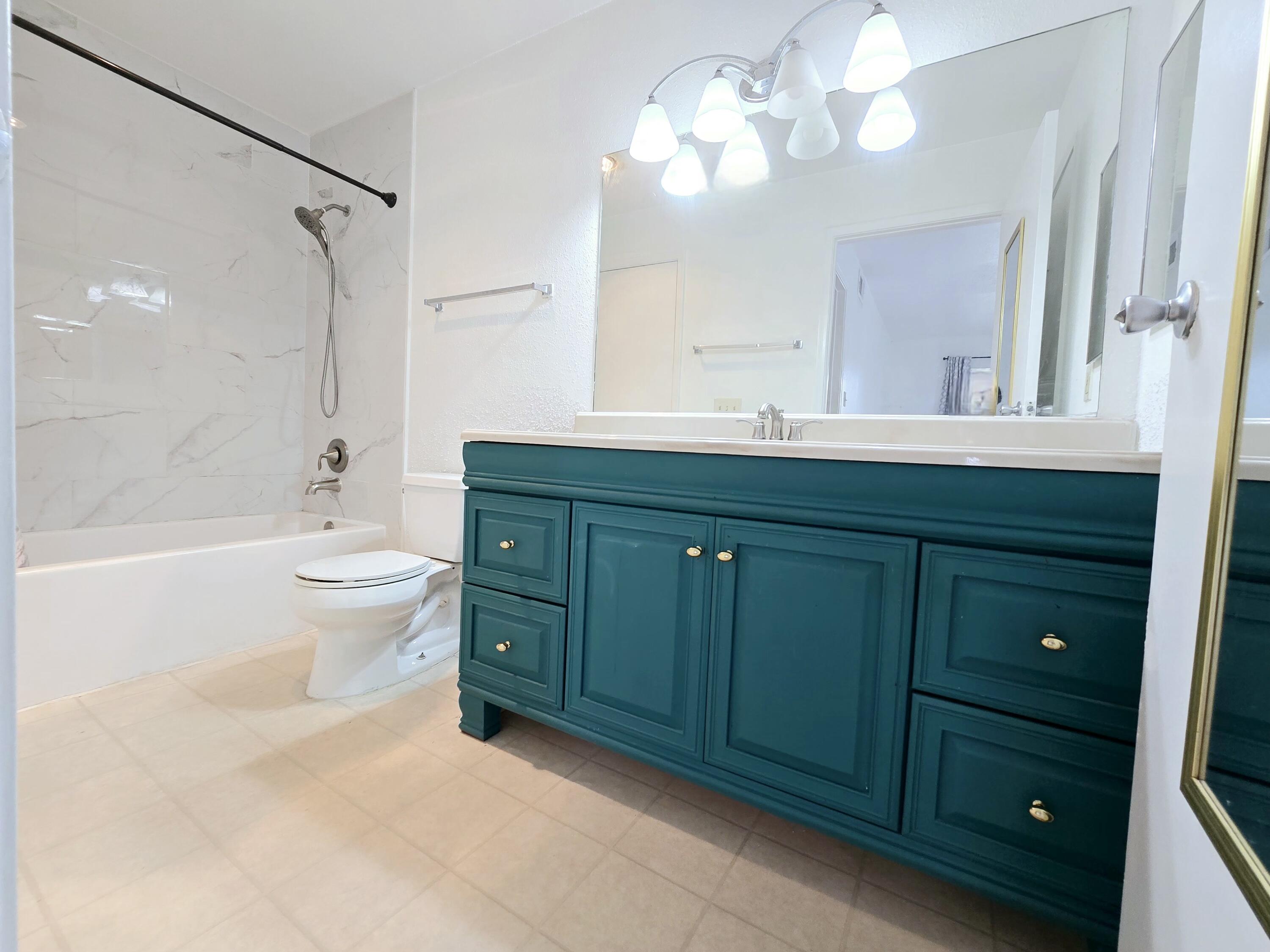 977 Riverside Drive, Unit 220 Coral Springs, FL 33071 - Photo 14 of 23 a bathroom with a double vanity sink mirror and toilet