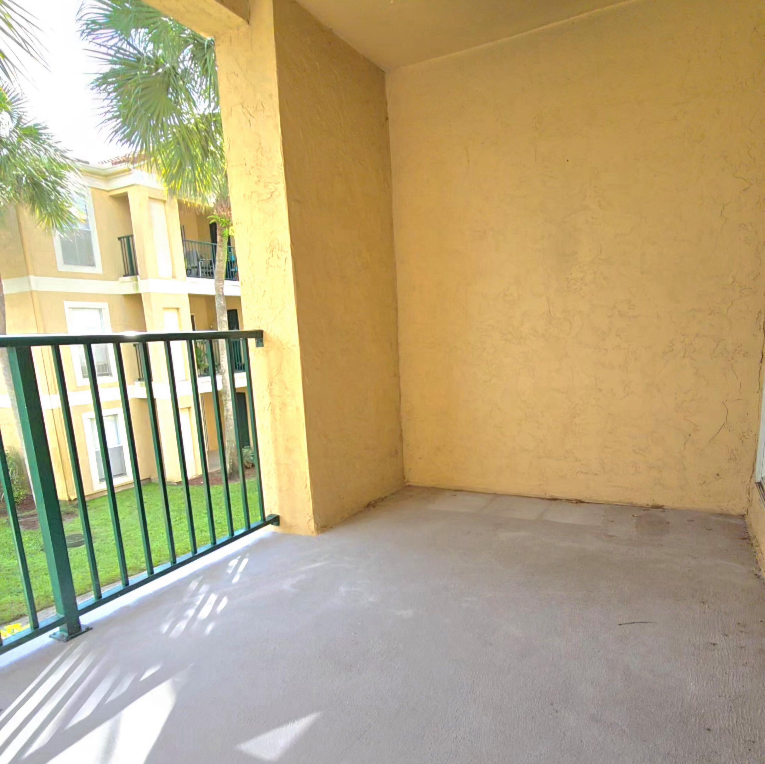 977 Riverside Drive, Unit 220 Coral Springs, FL 33071 - Photo 15 of 23 a view of a balcony with wooden fence