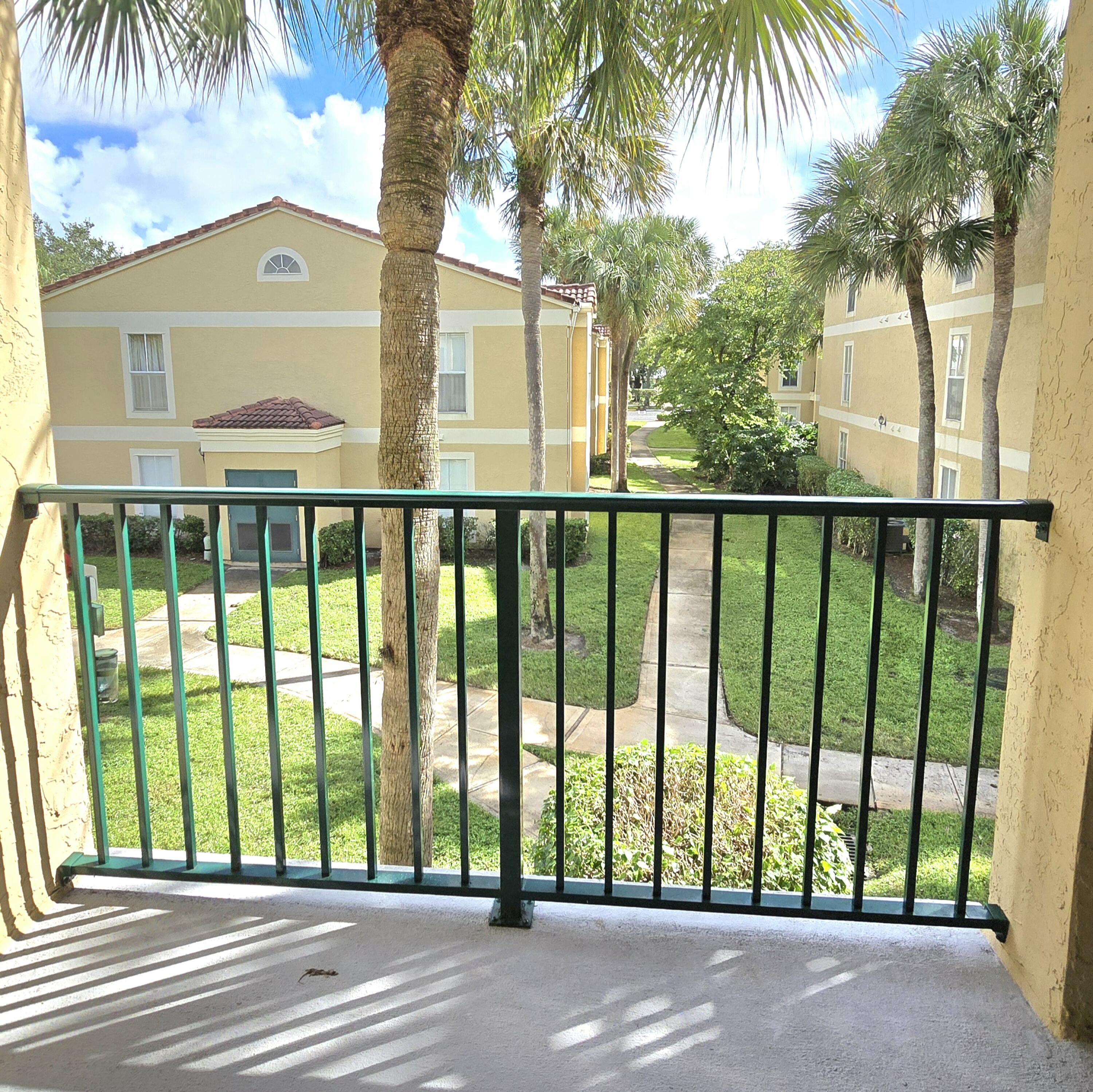977 Riverside Drive, Unit 220 Coral Springs, FL 33071 - Photo 17 of 23 a view of a large window and a palm tree