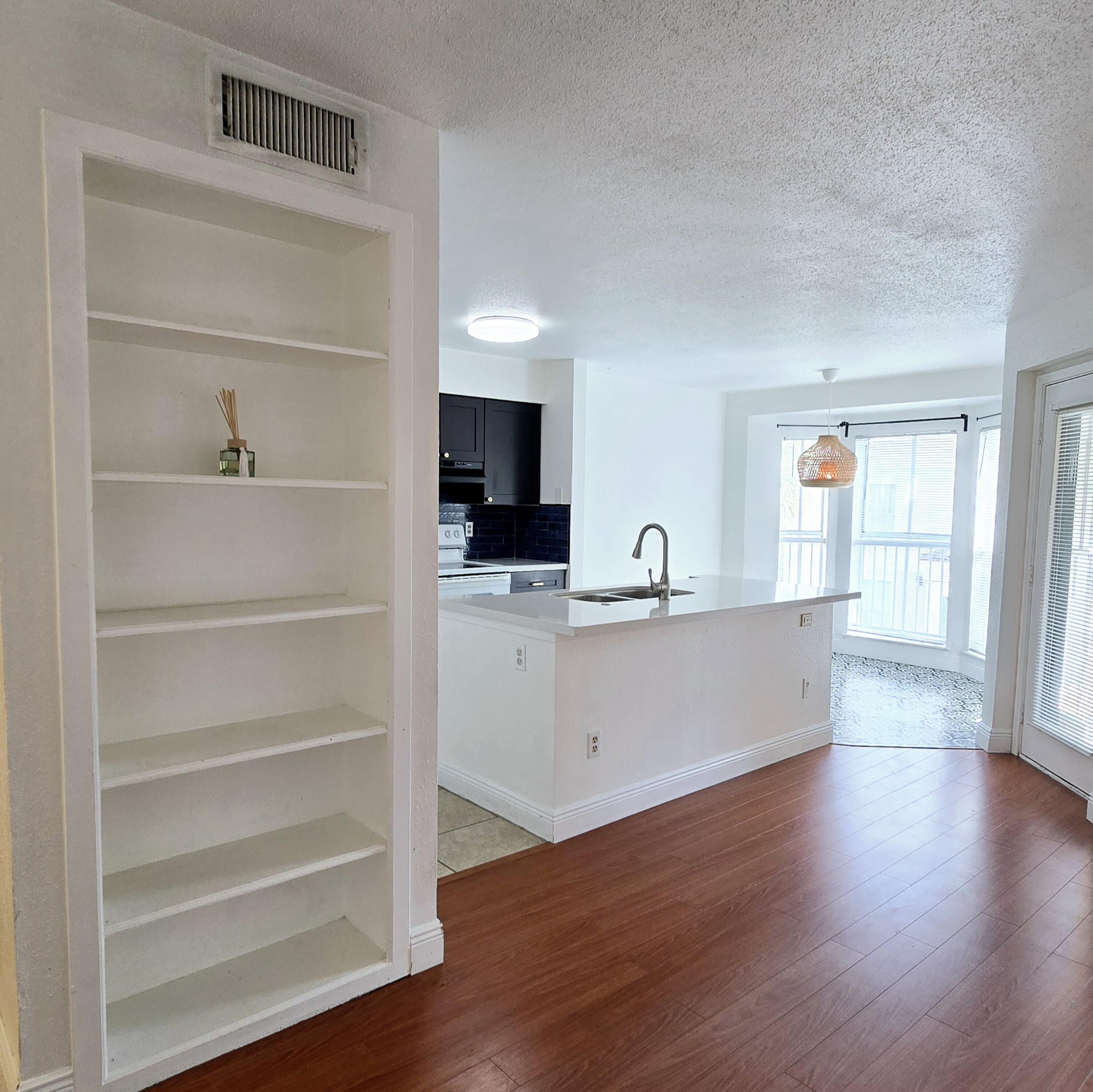 977 Riverside Drive, Unit 220 Coral Springs, FL 33071 - Photo 2 of 23 a view of kitchen with wooden floor and electronic appliances