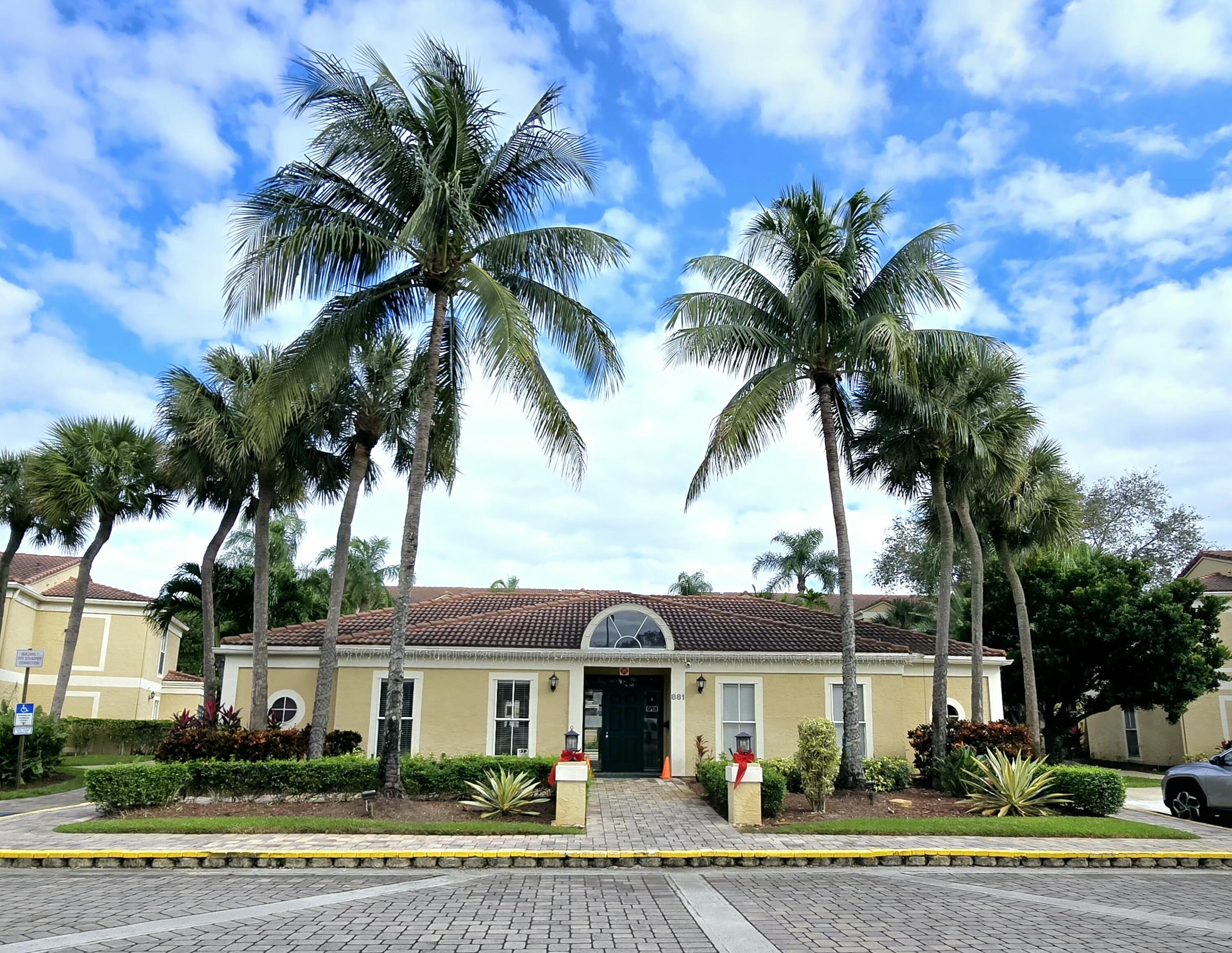 977 Riverside Drive, Unit 220 Coral Springs, FL 33071 - Photo 23 of 23 a front view of a house with a garden