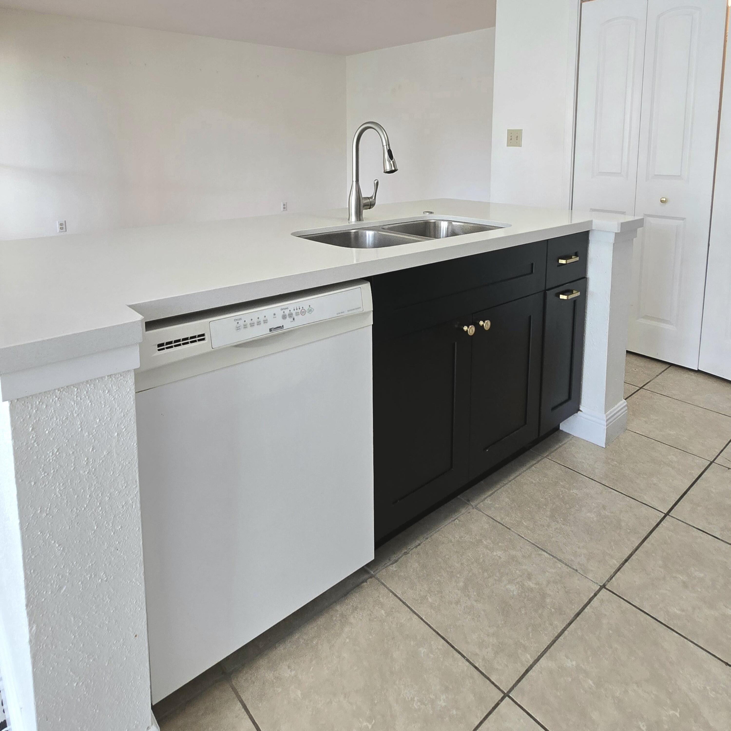 977 Riverside Drive, Unit 220 Coral Springs, FL 33071 - Photo 8 of 23 a kitchen with a sink and cabinets