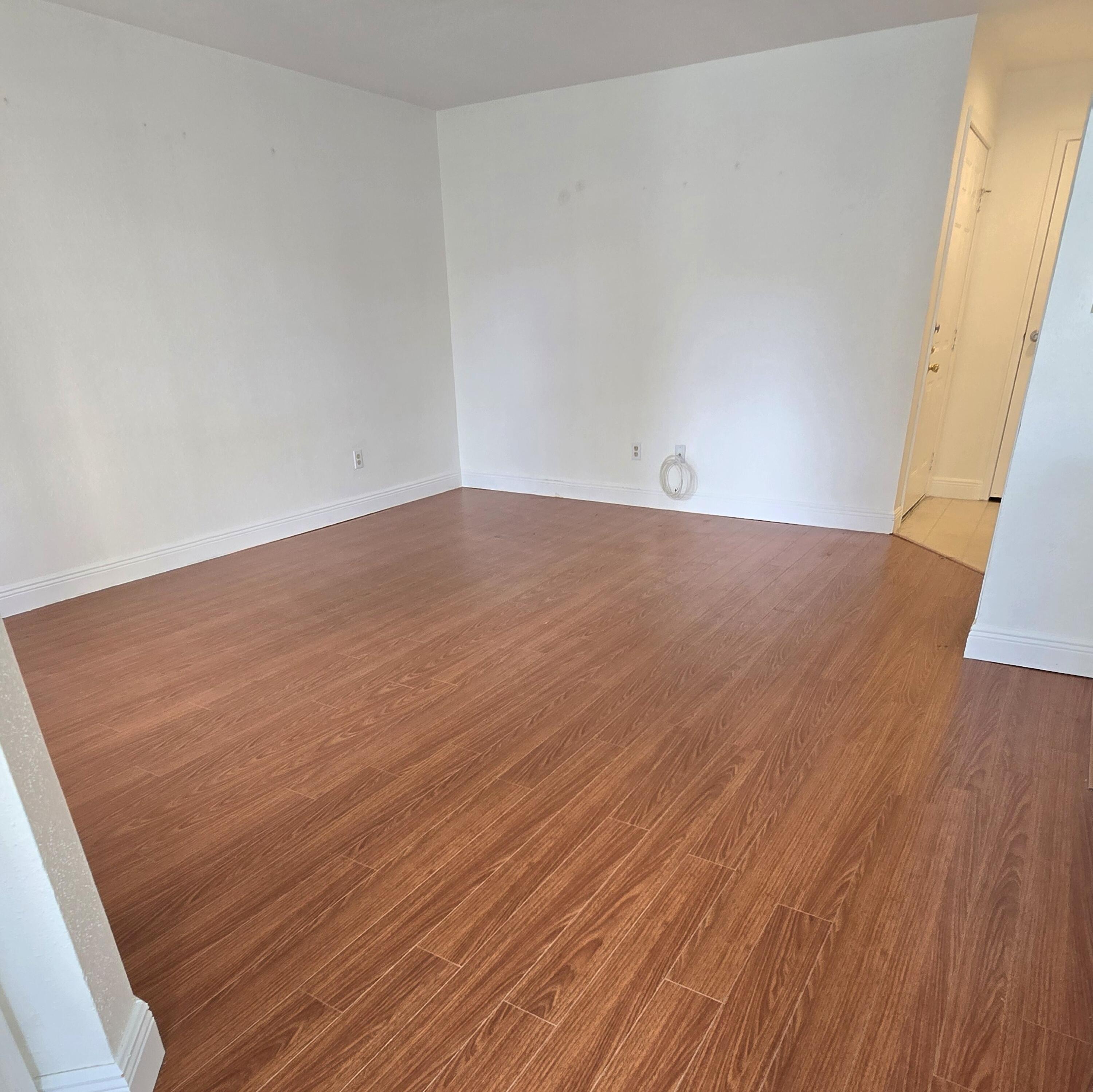 977 Riverside Drive, Unit 220 Coral Springs, FL 33071 - Photo 10 of 23 an empty room with wooden floor
