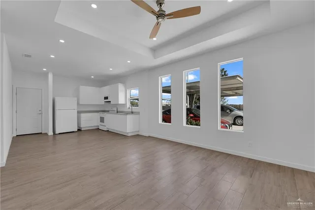 a view of a livingroom with wooden floor and a window