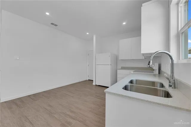 a kitchen with a sink and refrigerator