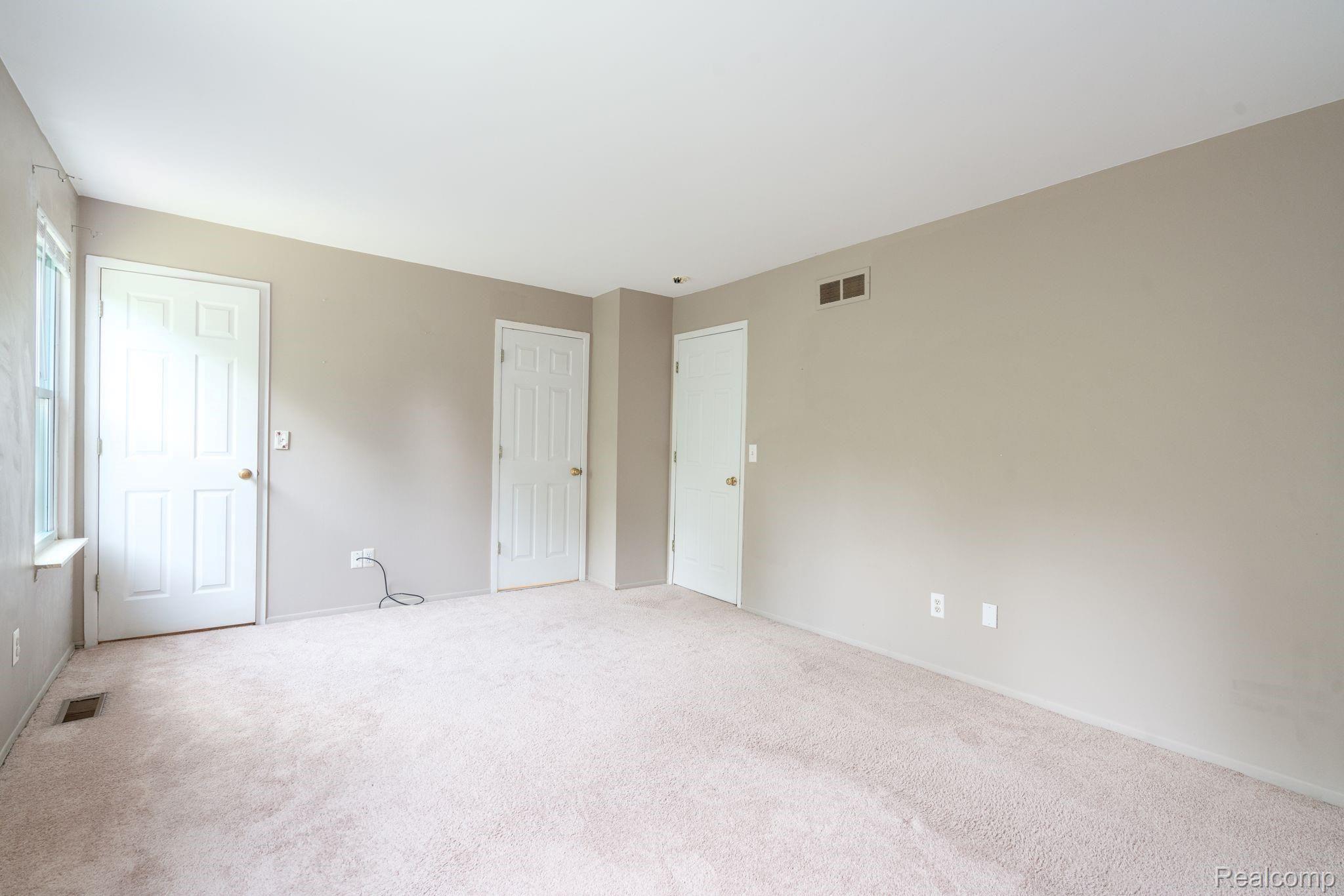 645 Worthington Road Canton, MI 48188 - Photo 13 of 30 Master Bedroom with walk in closet, access to hall and bathroom, and two large windows with natural light.
