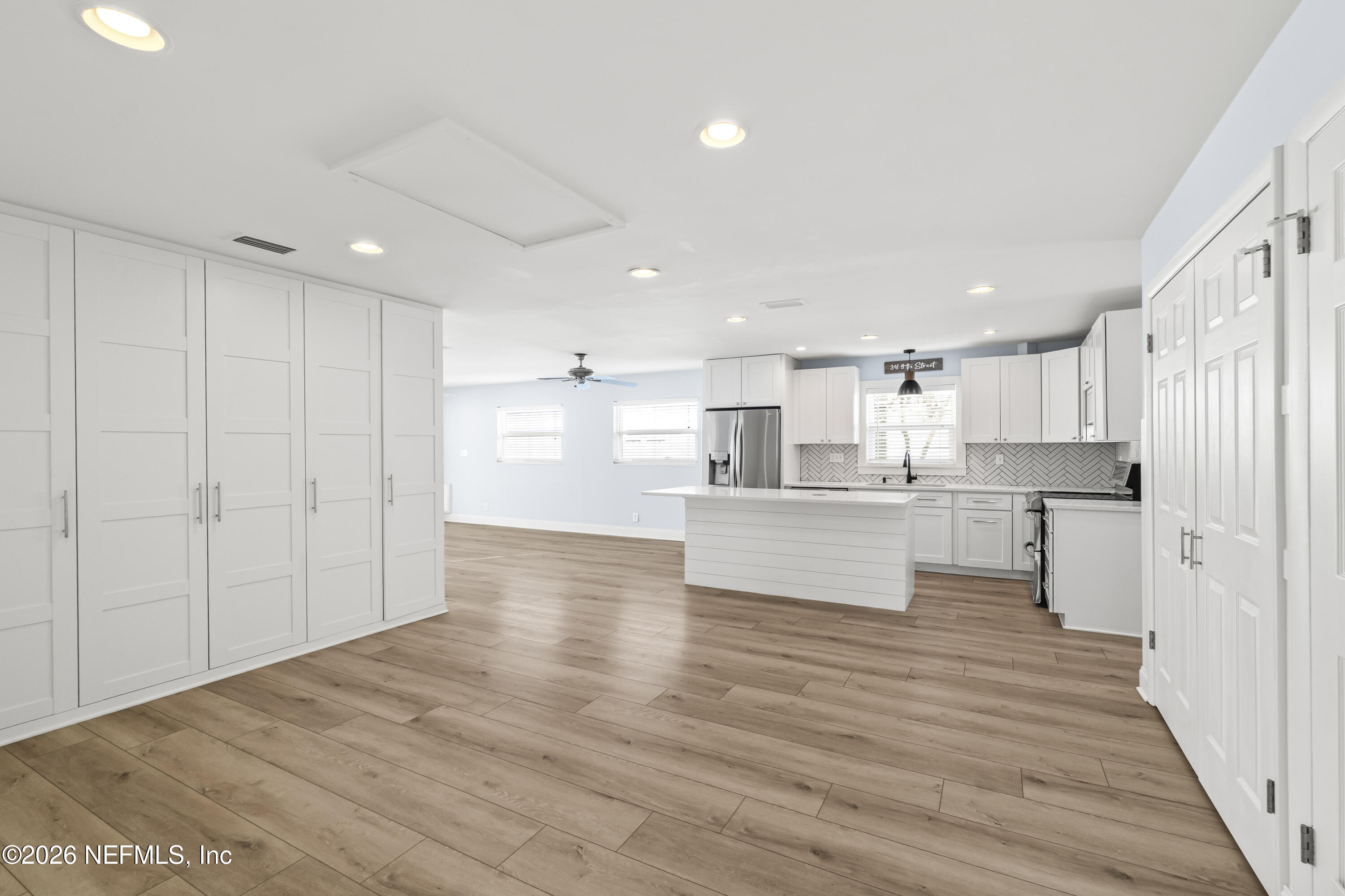 341 9th Street Atlantic Beach, FL 32233 - Photo 11 of 35 a view of kitchen dining table chairs microwave and cabinets