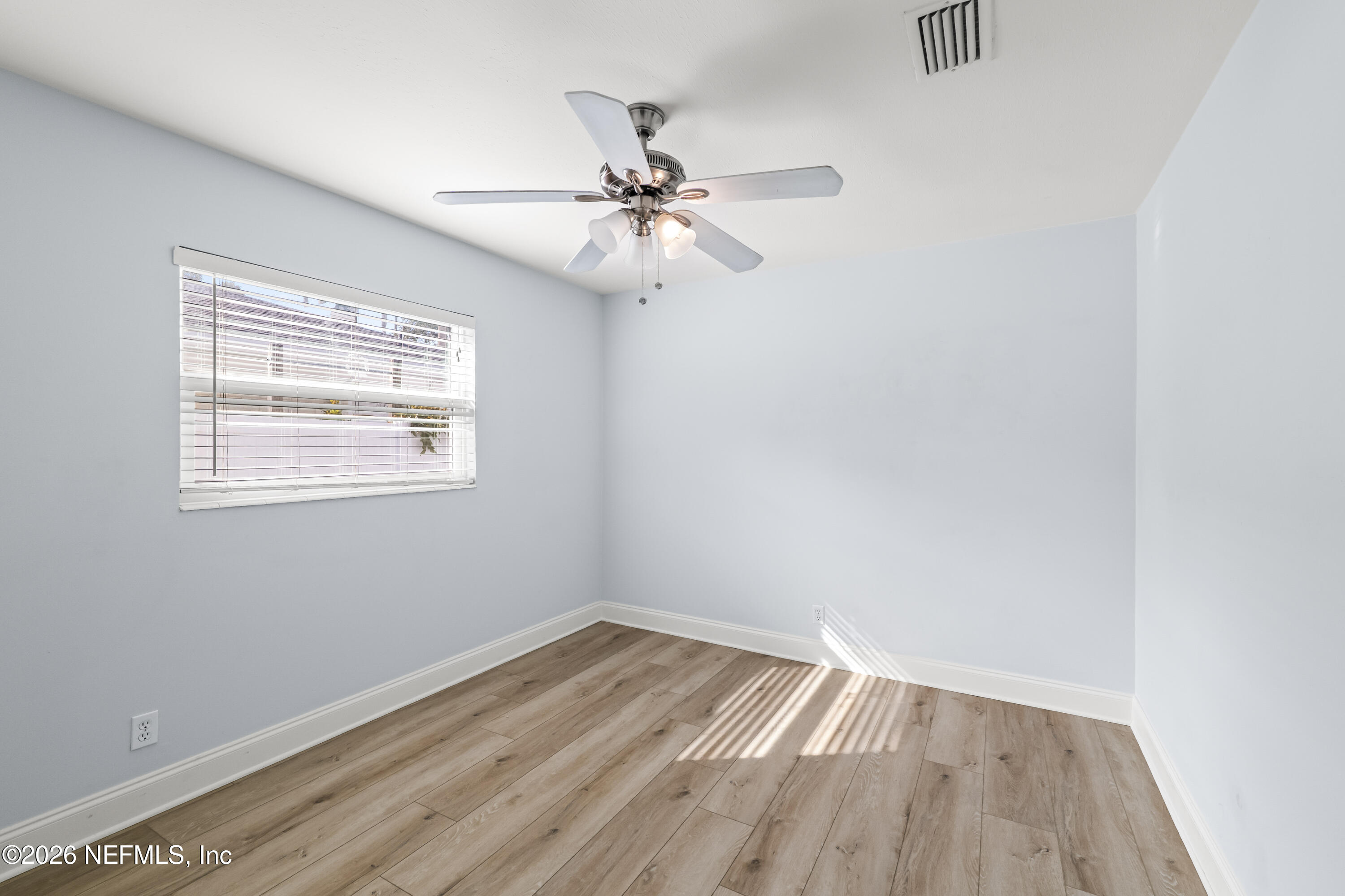 341 9th Street Atlantic Beach, FL 32233 - Photo 15 of 35 an empty room with a window and ceiling fan