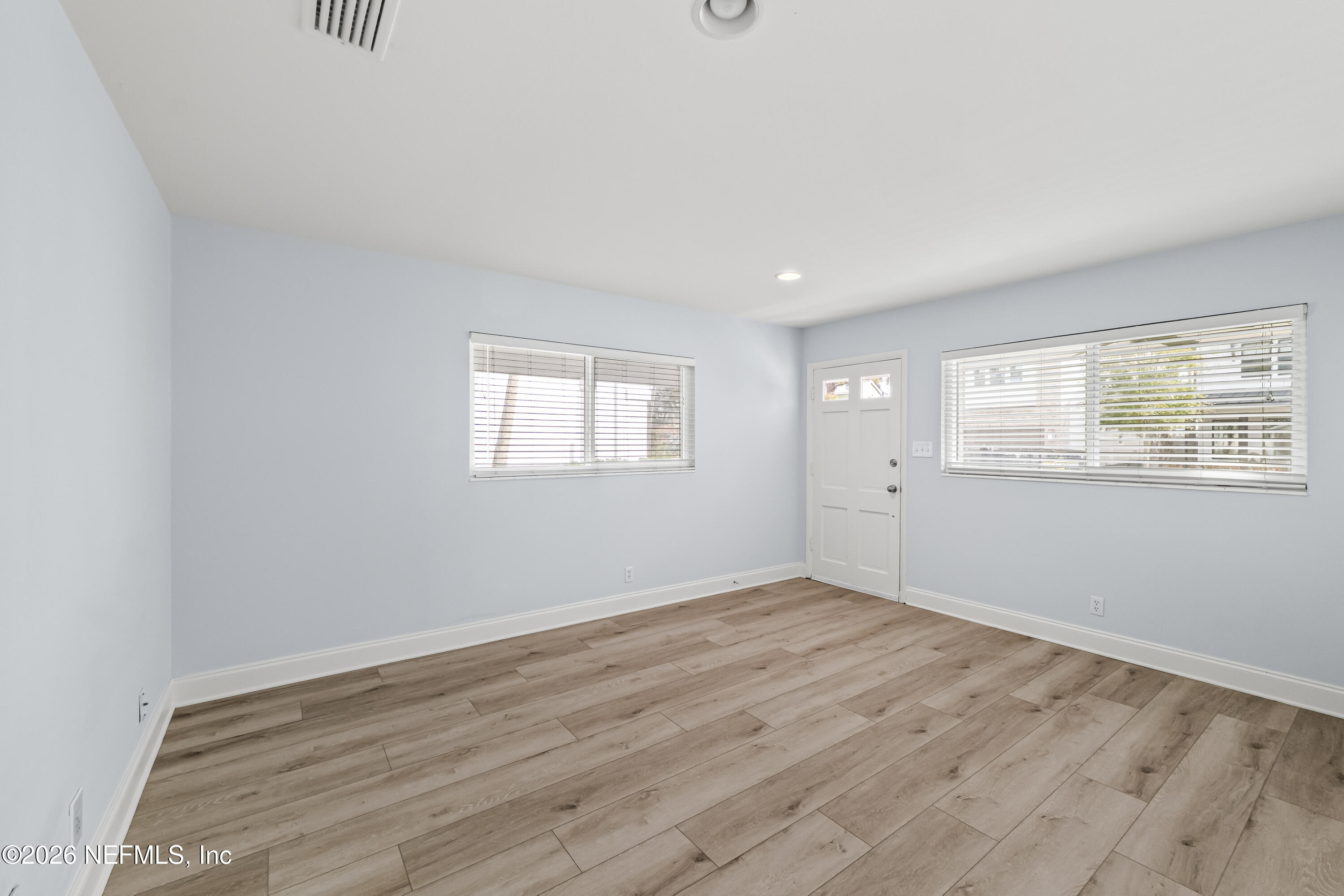 341 9th Street Atlantic Beach, FL 32233 - Photo 17 of 35 a view of an empty room with wooden floor and a window