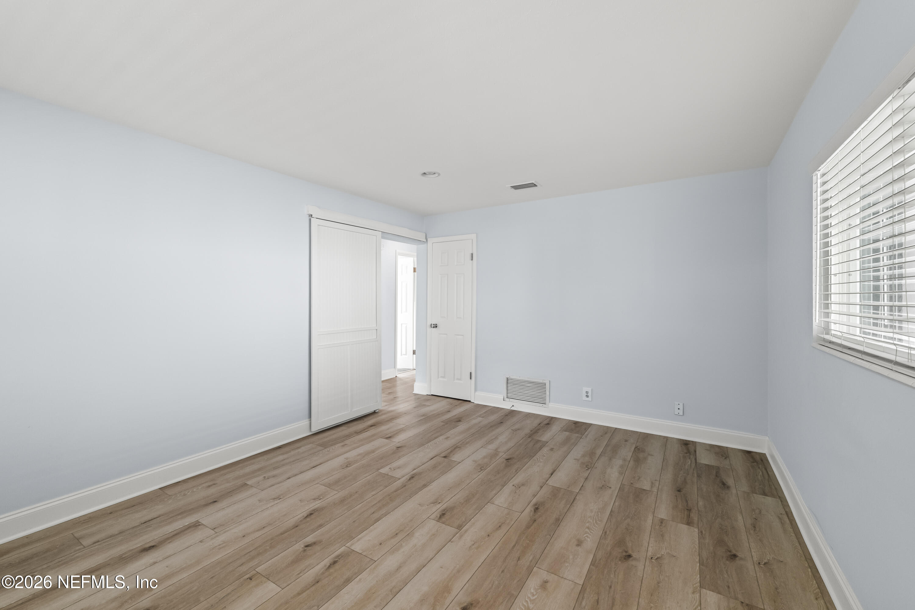 341 9th Street Atlantic Beach, FL 32233 - Photo 18 of 35 an empty room with wooden floor and windows