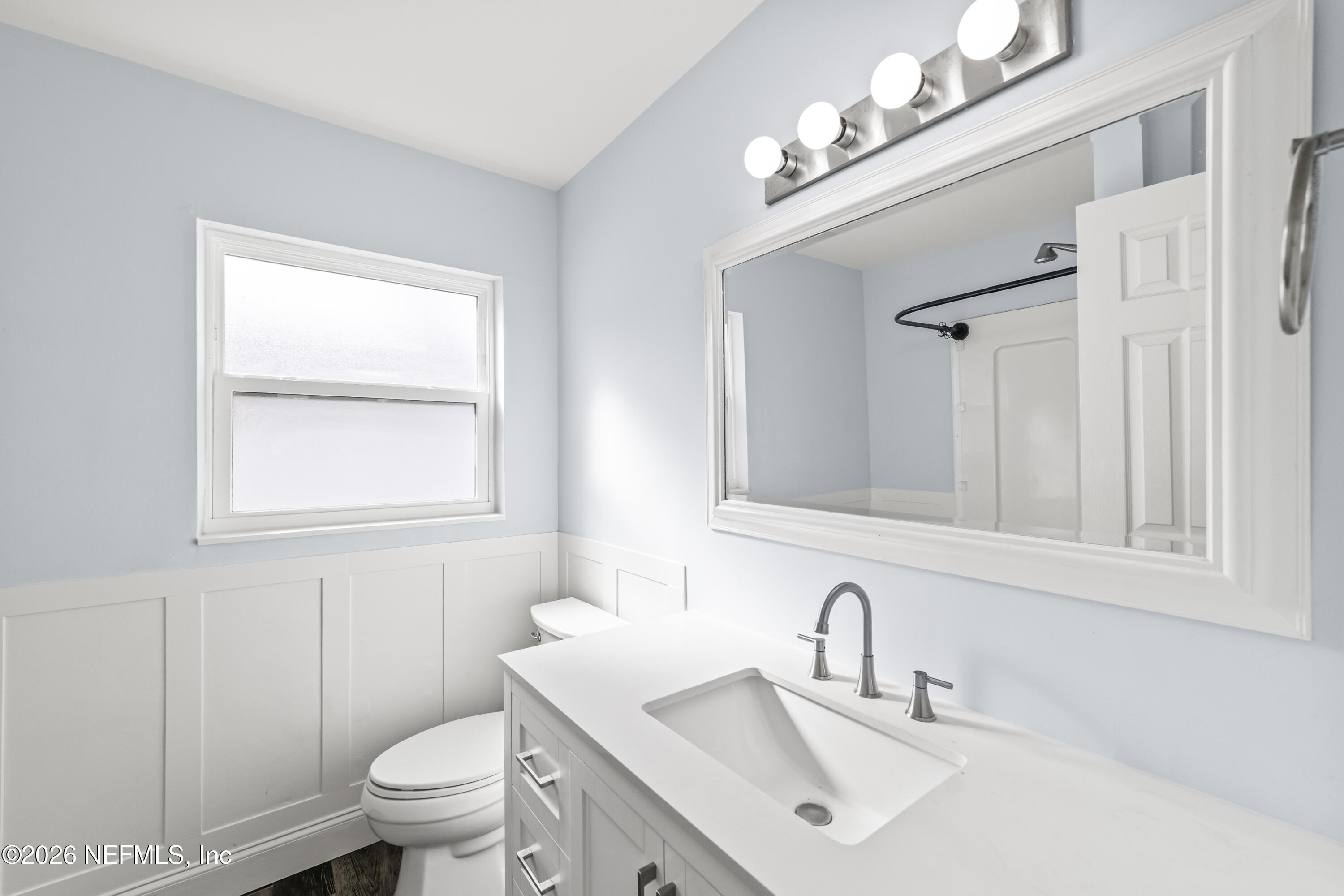 341 9th Street Atlantic Beach, FL 32233 - Photo 22 of 35 a bathroom with a sink vanity mirror and toilet