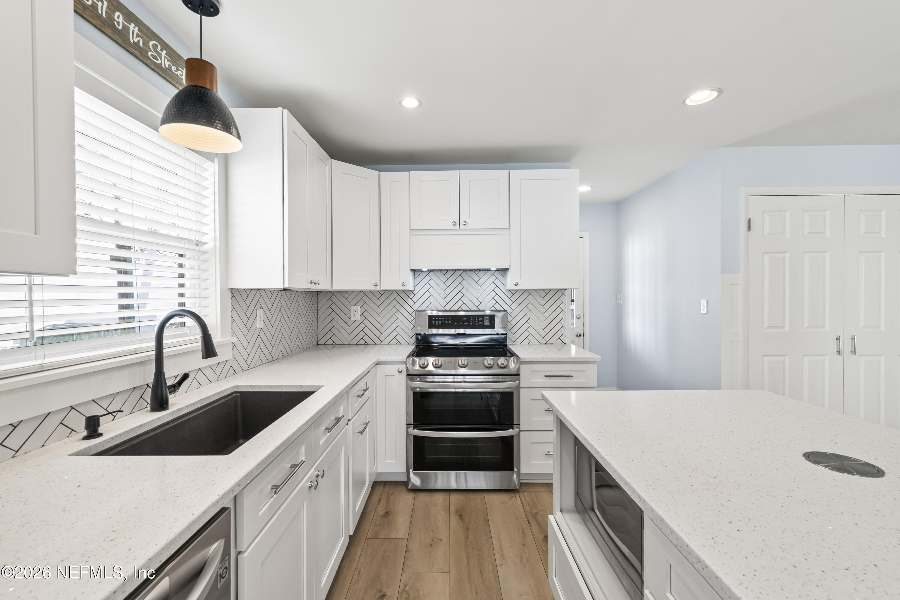 341 9th Street Atlantic Beach, FL 32233 - Photo 8 of 35 a kitchen with a sink stove and cabinets
