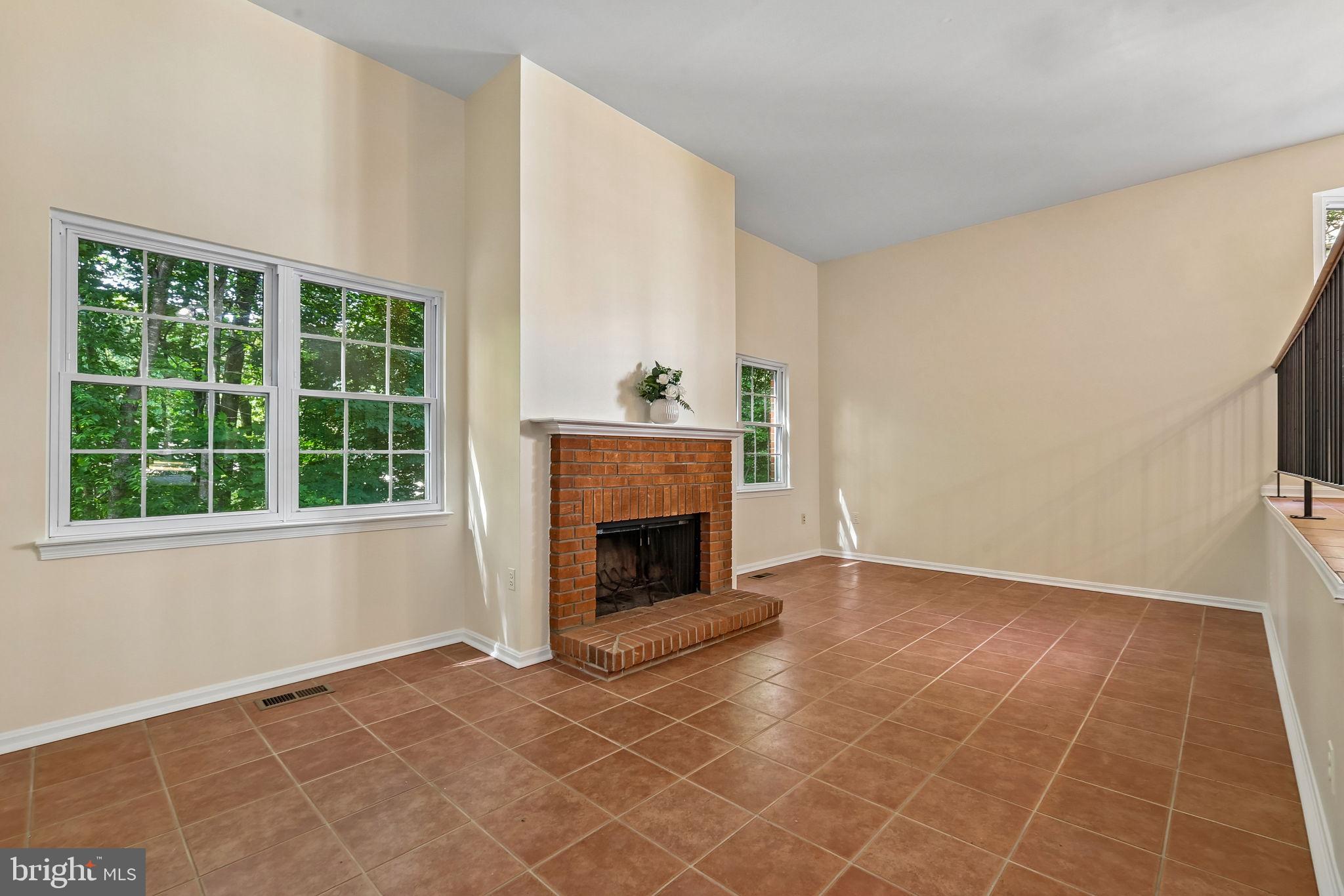 11714 Dry River Court Reston, VA 20191 - Photo 4 of 24 a view of an empty room with a fireplace and a window