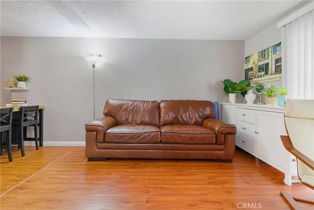 a living room with a flat screen tv and a floor to ceiling window