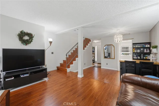 a living room with furniture and a wooden floor
