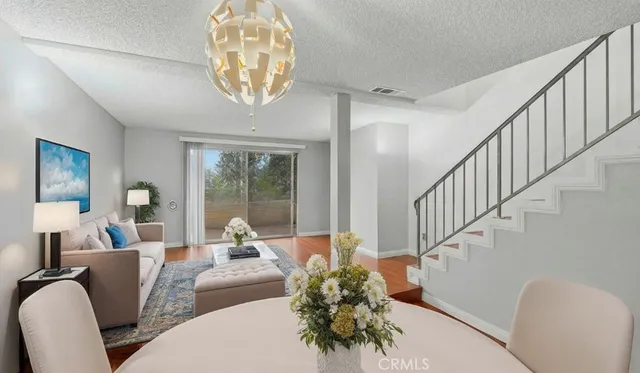 a living room with furniture chandelier and a chandelier