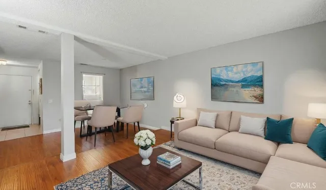 a living room with furniture wooden floor and a table