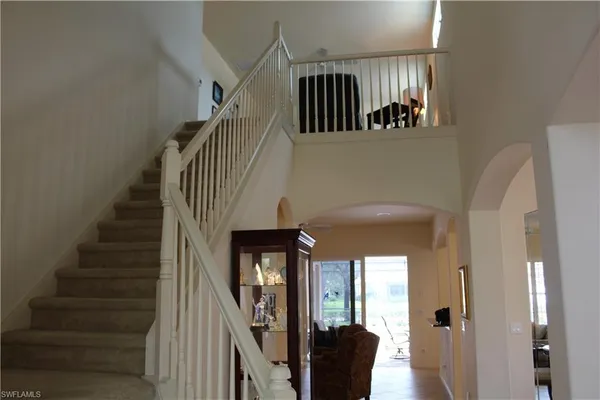 a view of entryway and hall with a mirror