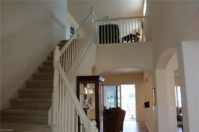 a view of entryway and hall with a mirror