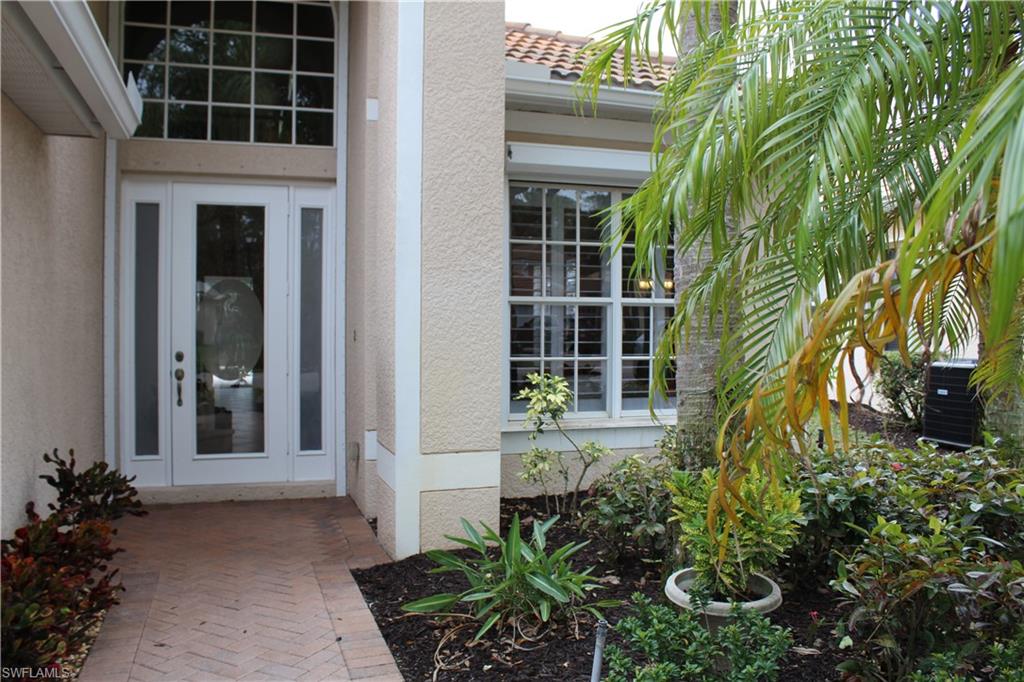 6478 Waverly Green Way Naples, FL 34110 - Photo 2 of 28 front view of a house with a potted plant and floor to ceiling windows