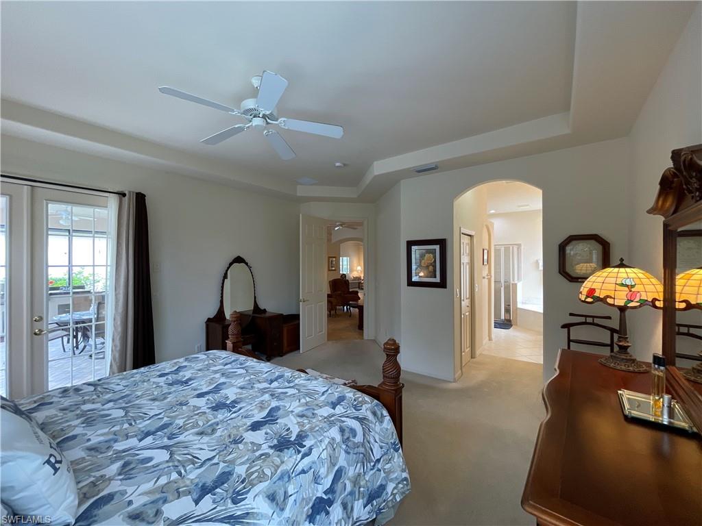 6478 Waverly Green Way Naples, FL 34110 - Photo 21 of 28 a bedroom with a bed and dresser with mirror