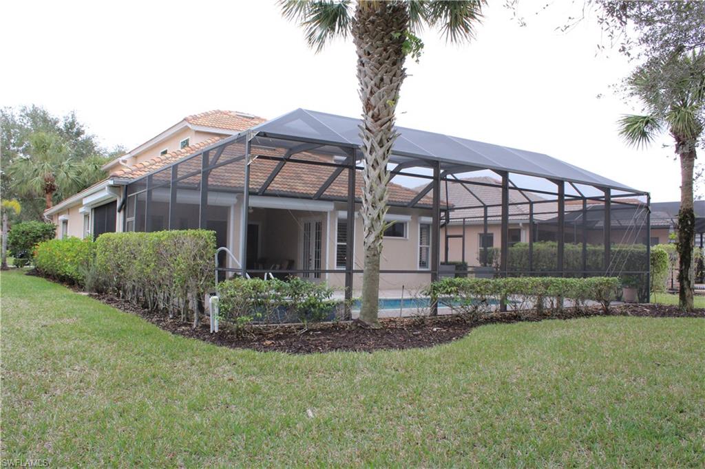 6478 Waverly Green Way Naples, FL 34110 - Photo 24 of 28 a front view of a house with garden