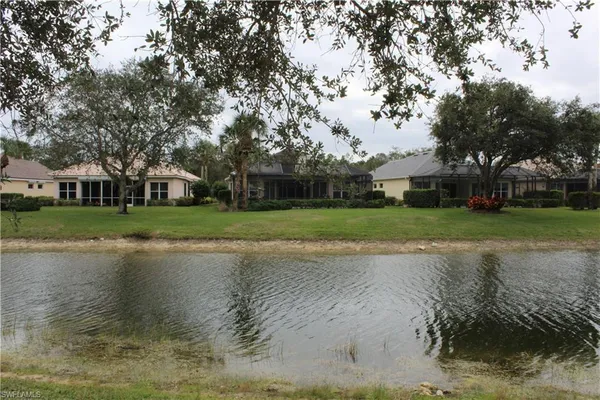 a view of a lake with houses in background