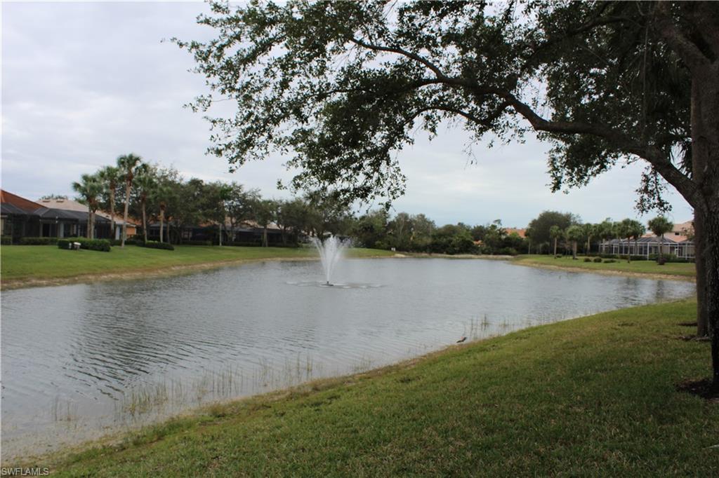6478 Waverly Green Way Naples, FL 34110 - Photo 27 of 28 a view of a lake with houses in background