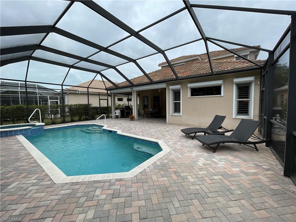 6478 Waverly Green Way Naples, FL 34110 - Photo 6 of 28 a view of a swimming pool with a patio