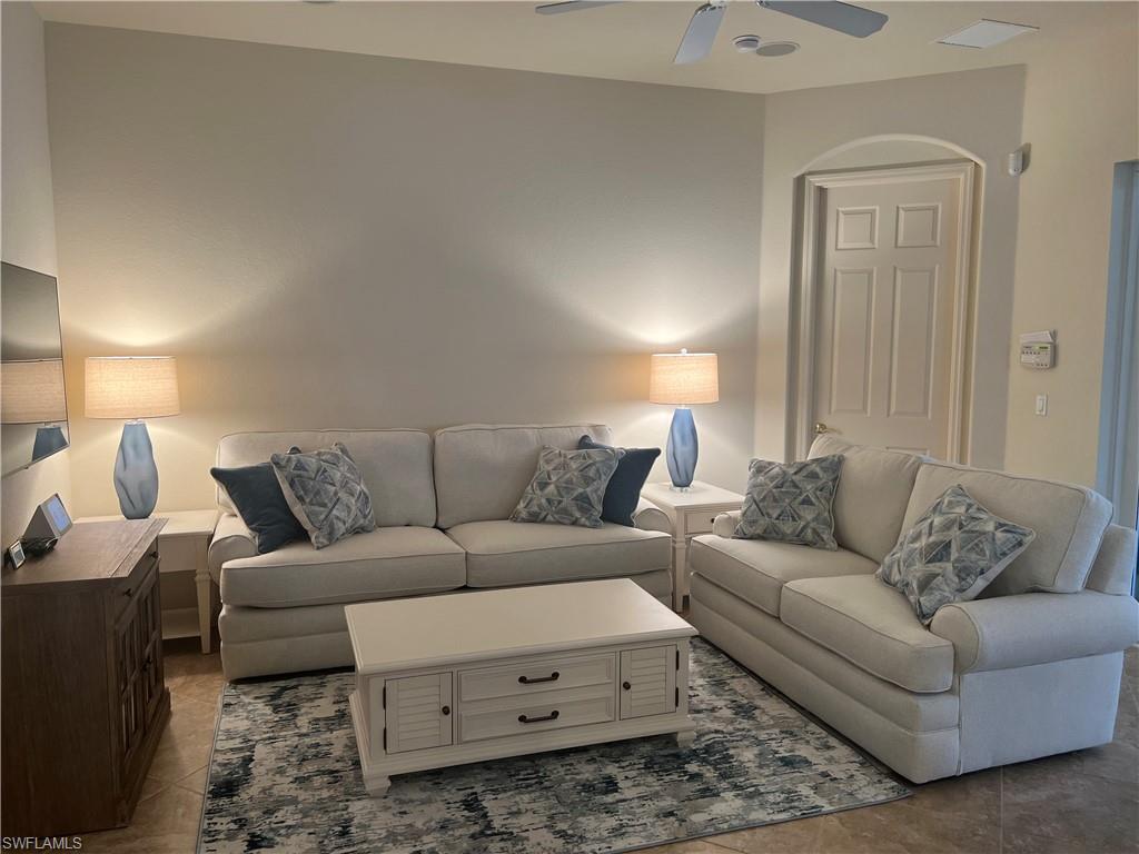 6478 Waverly Green Way Naples, FL 34110 - Photo 8 of 28 a living room with furniture and a couch