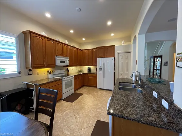 a kitchen with refrigerator and cabinets