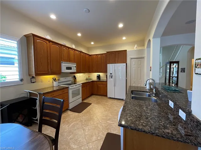 a kitchen with refrigerator and cabinets